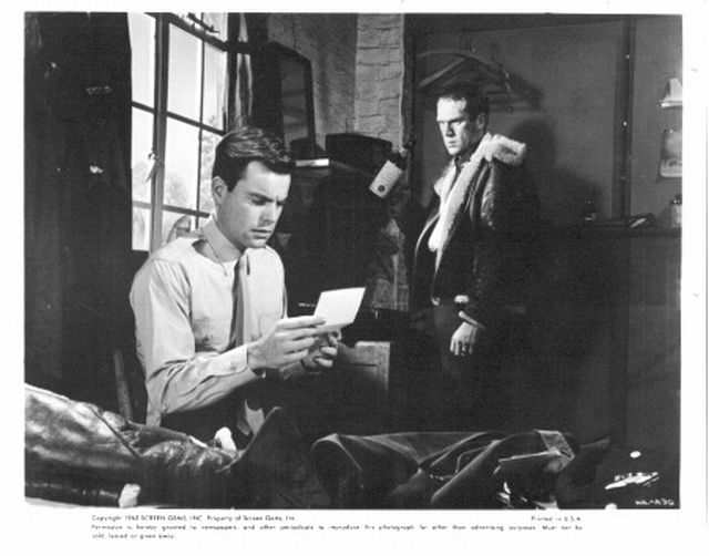 Robert Wagner (as Bo) reads a letter from his girl, as  Steve McQueen (as Buzz Rickson) stands in the background.